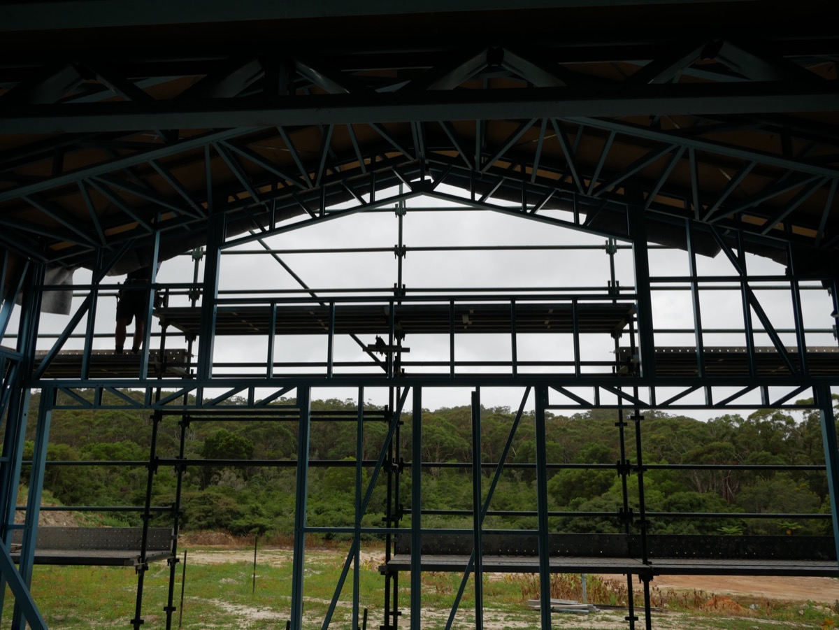 Steel portal frame of a building under construction against open sky
