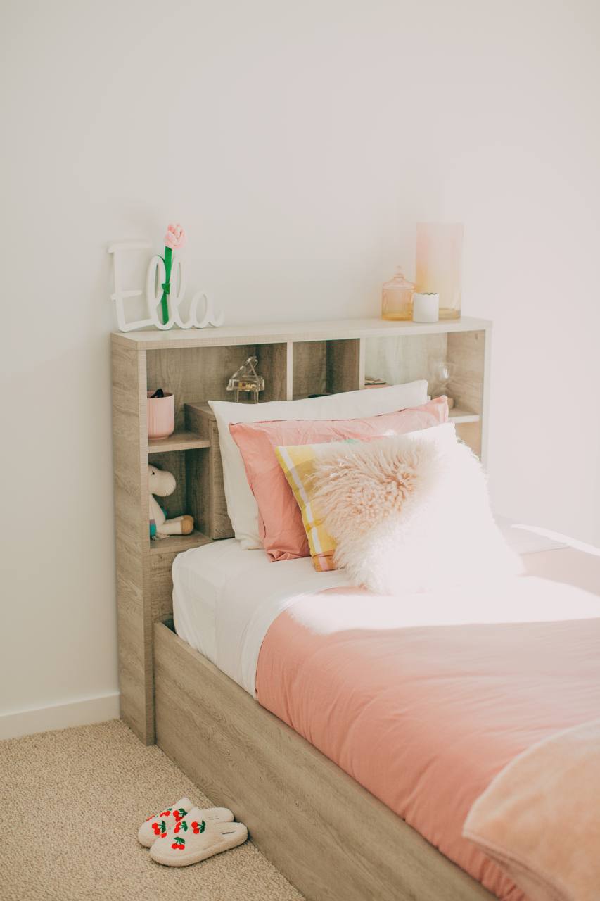 Second bedroom with a built-in shelving headboard in the Castle Hill home