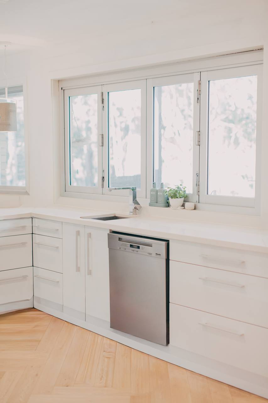 Kitchen detail with white cabinetry and integrated appliances in the Castle Hill home