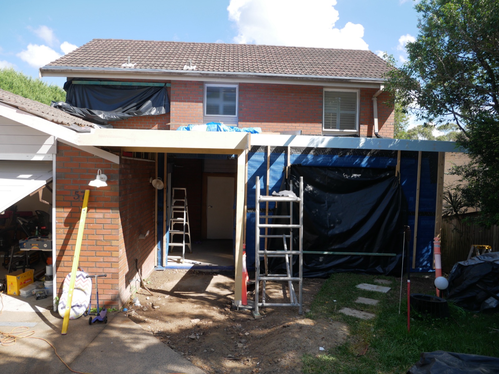The new front extension of the Frenchs Forest home framed up against the original brick facade