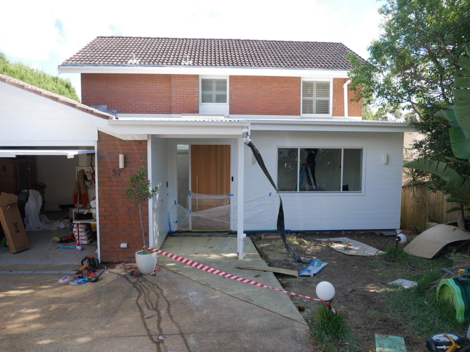 Renovated Frenchs Forest home with new white-clad front extension and entry portico, AGATHĒ Builders