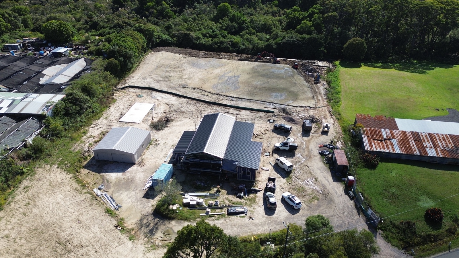 Aerial view of the Ingleside home with its dark Colorbond roof installed and the garage complete