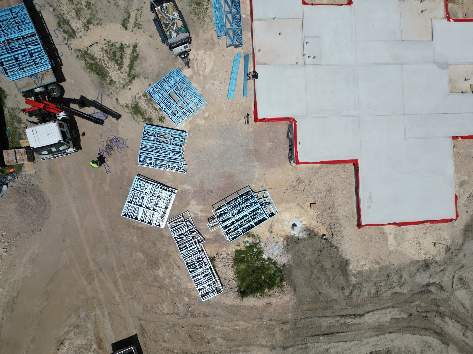 Top-down aerial view of the freshly poured concrete house slab at Ingleside with steel wall frames laid out around it