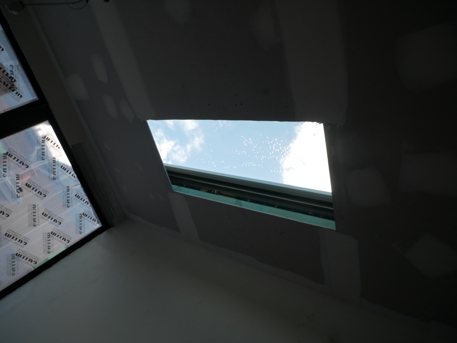 Full-height mirror wall in a black steel frame installed in the Redfern terrace renovation
